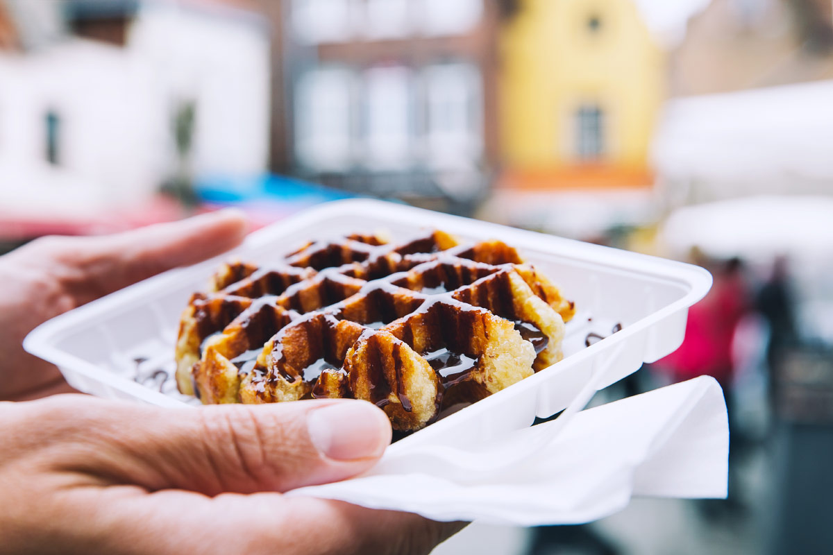 Man holding chocolate Belgian waffles food bucket list