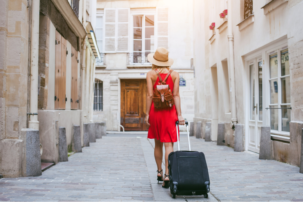 woman with suitcase Europe packing like a pro